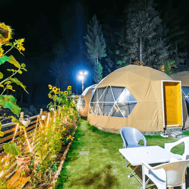 Illuminated domes and a sunflower at night in Kumrat Valley.