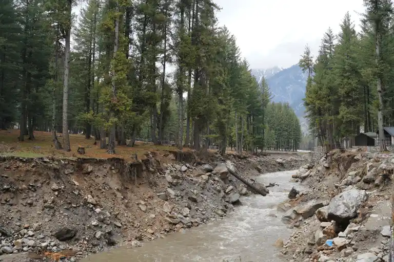 River flowing through Kumrat Valley with trees.