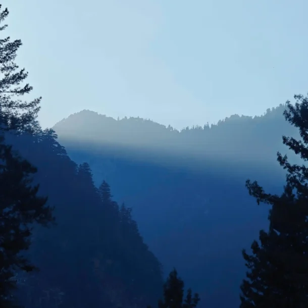 Mountain landscape with mist, representing luxury escapes to nature.