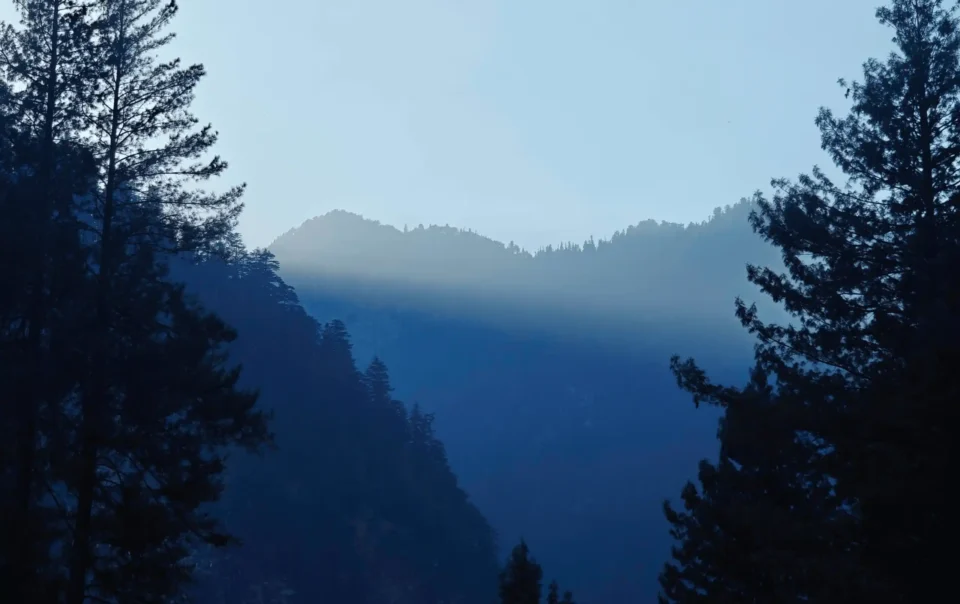Mountain landscape with mist, representing luxury escapes to nature.